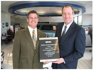 Tom Finley receivng an award for 25 years as a GM dealer